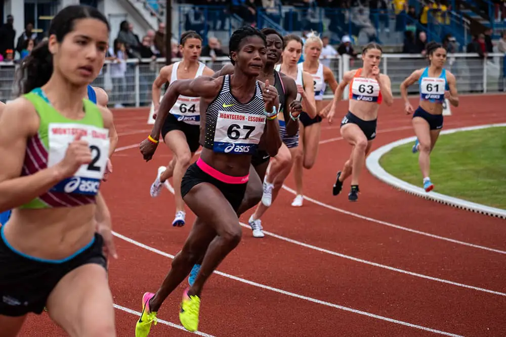 Sprinters rounding track curve